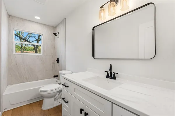 a bathroom with a sink a toilet and a mirror