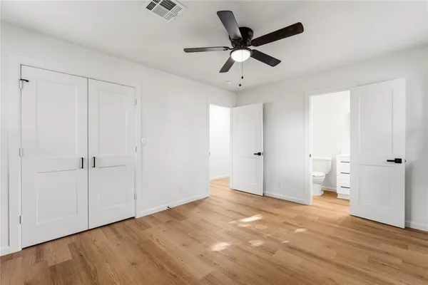 a view of an empty room and wooden floor
