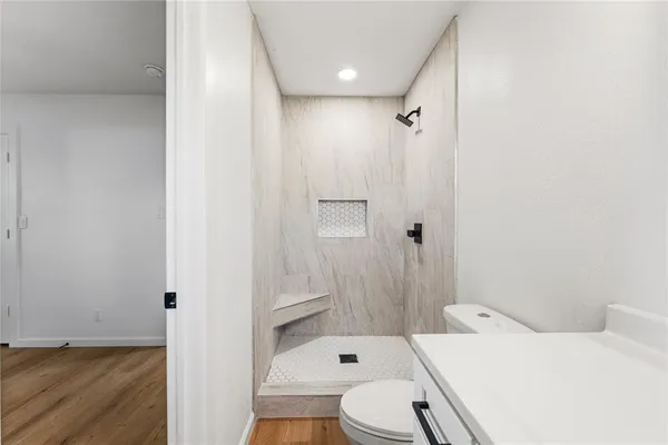 a bathroom with a sink toilet and shower