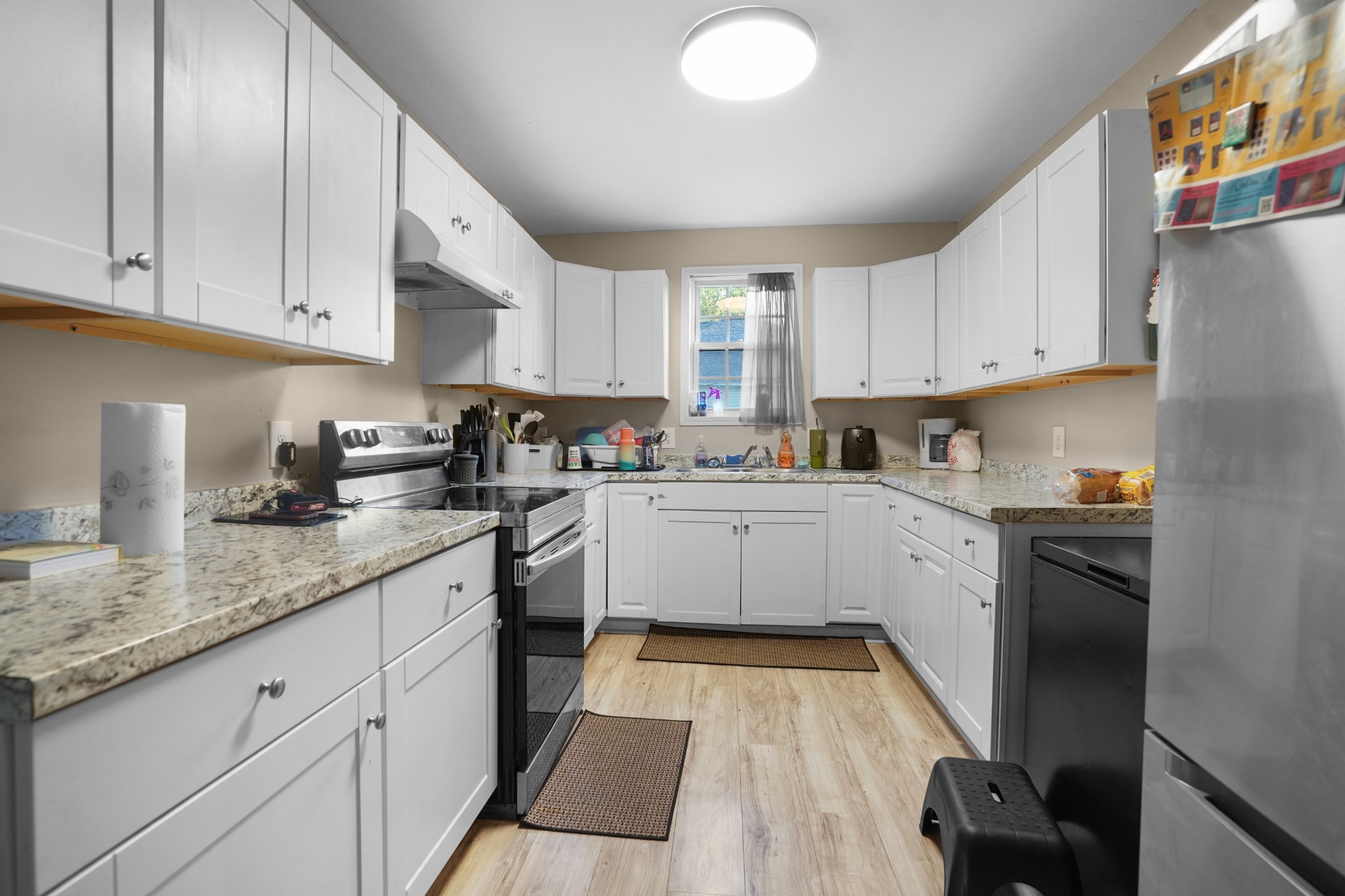 403 Victoria Street Pulaski, TN 38478 - Photo 5 of 21 a kitchen with granite countertop white cabinets and white appliances