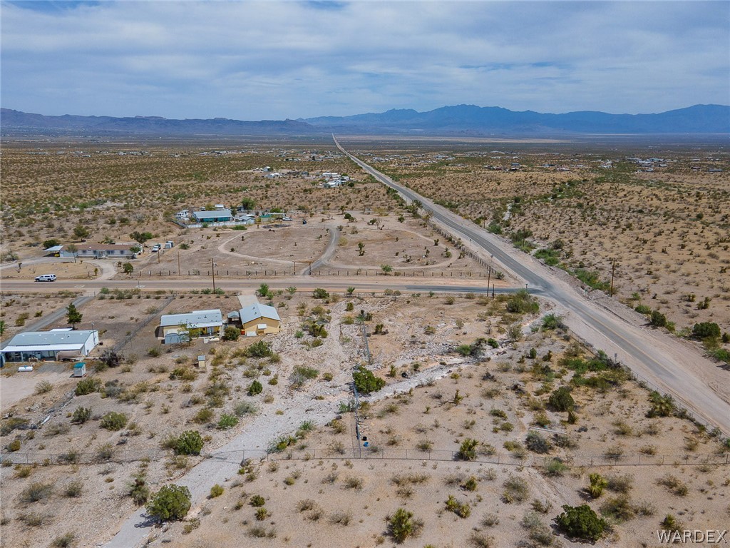 2465 Egar Road Golden Valley, AZ 86413 - Photo 97 of 98 Expansive property with a desert landscape, featuring a paved road and mountain views in the distance