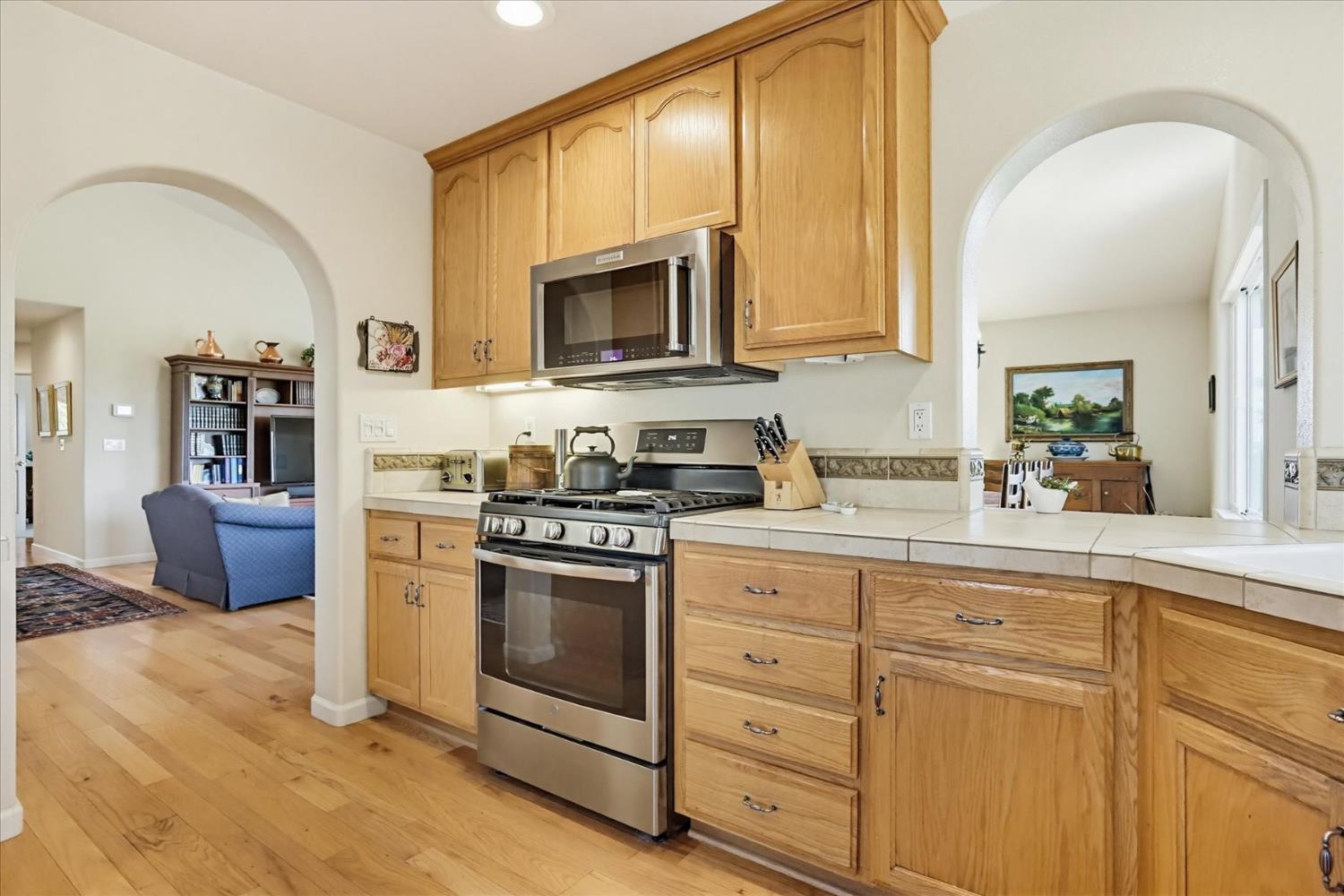 970 Morgan Ranch Drive Grass Valley, CA 95945 - Photo 18 of 76 a kitchen with cabinets stainless steel appliances and wooden floor
