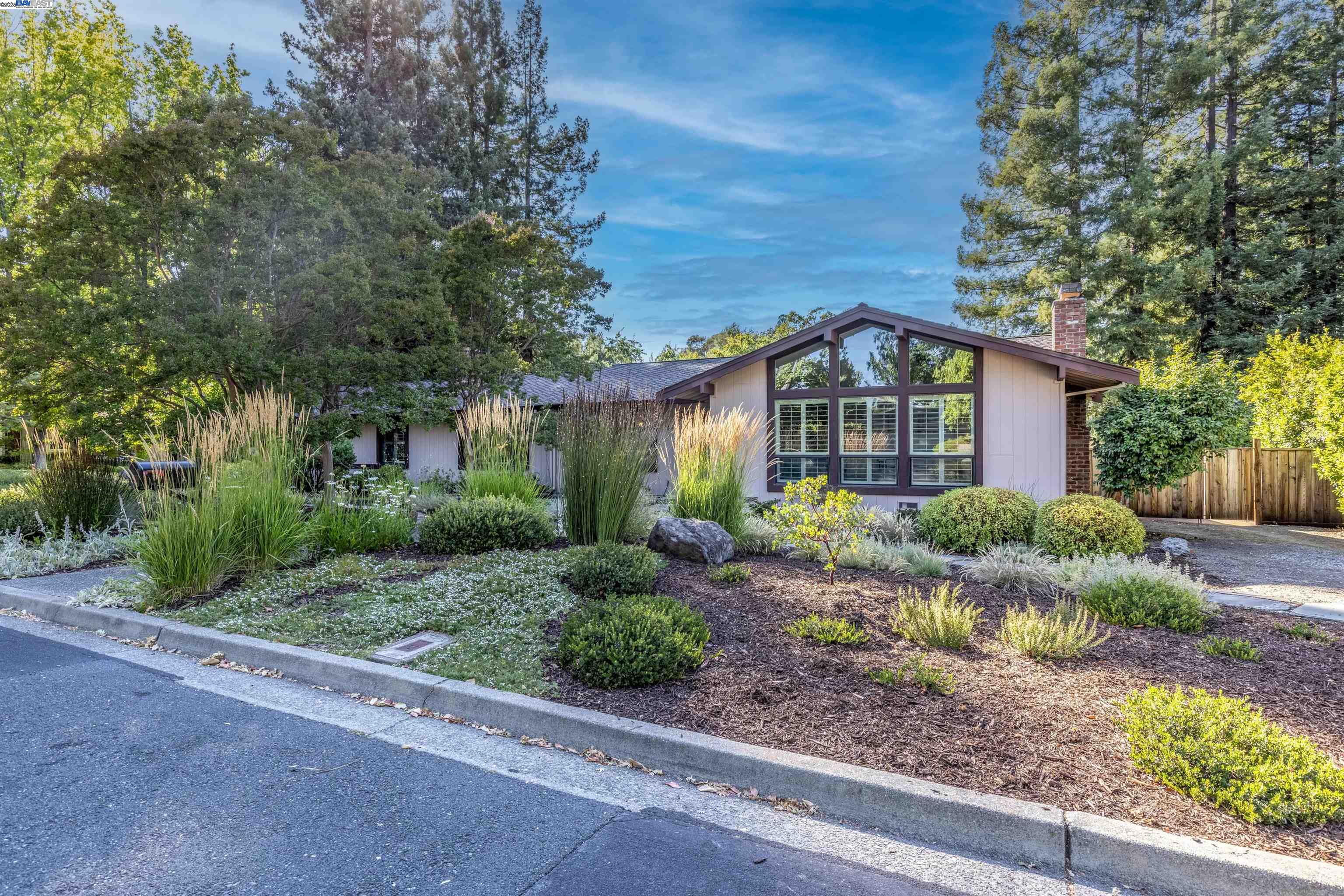 a front view of house with yard and green space