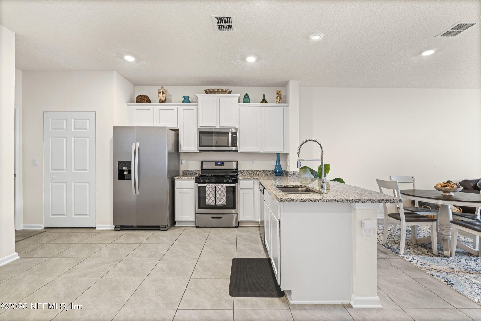 349 Coastline Way Street St. Augustine, FL 32092 - Photo 4 of 16 a kitchen with stainless steel appliances granite countertop a stove a sink and a refrigerator