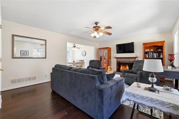 a living room with furniture a fireplace and a flat screen tv