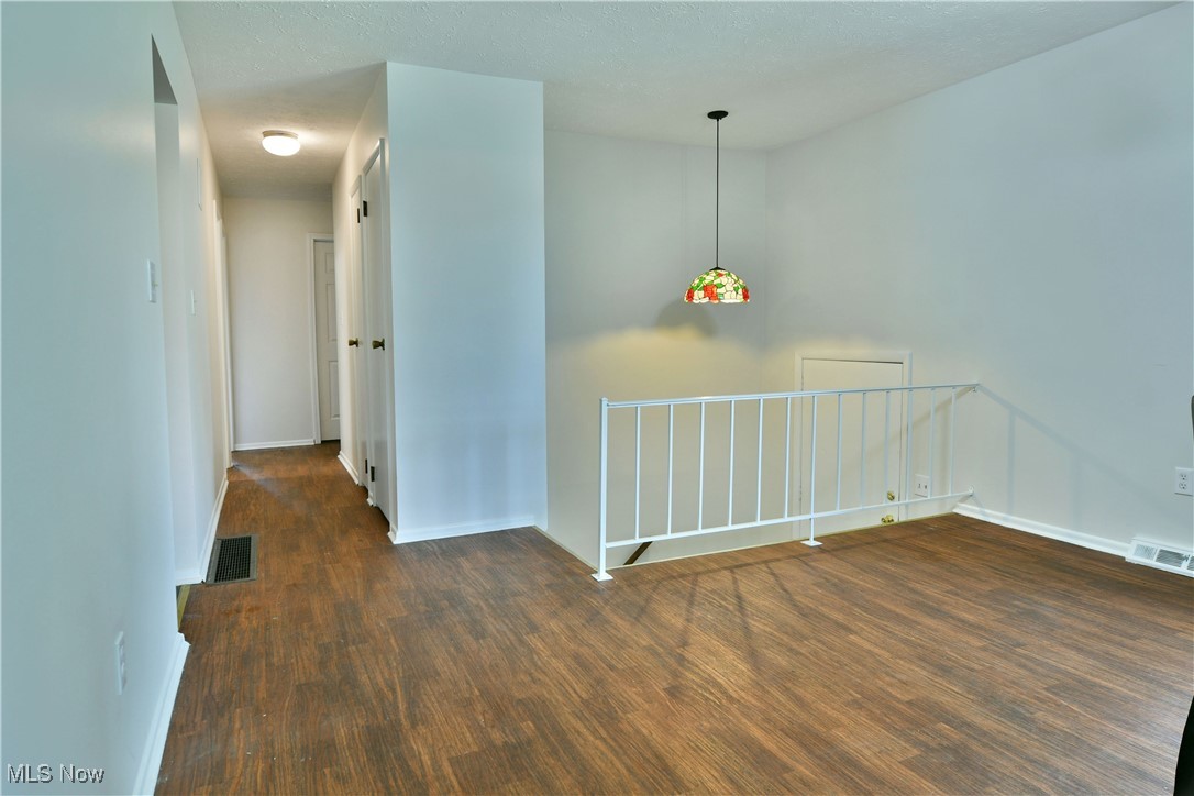 234 Howland Wilson Road Northeast Warren, OH 44484 - Photo 6 of 37 Empty room with wood finished floors and a textured ceiling