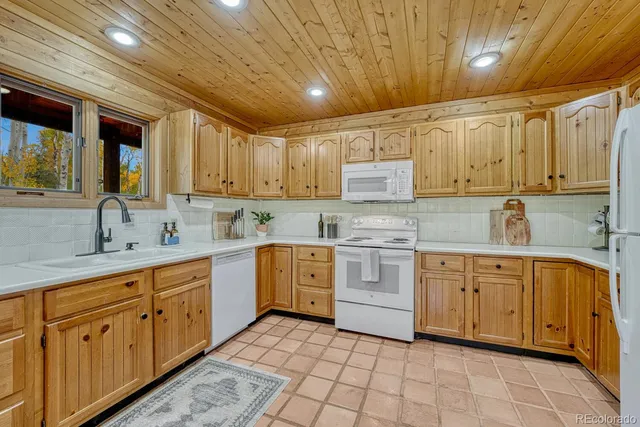 a kitchen with cabinets appliances and a counter space