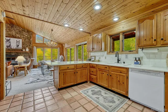 a kitchen with a refrigerator a stove top oven and cabinets