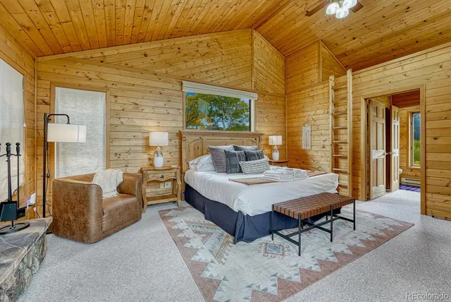 a spacious bedroom with a bed and a fireplace