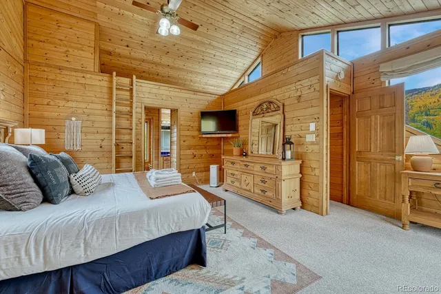 a spacious bedroom with a bed and a fireplace