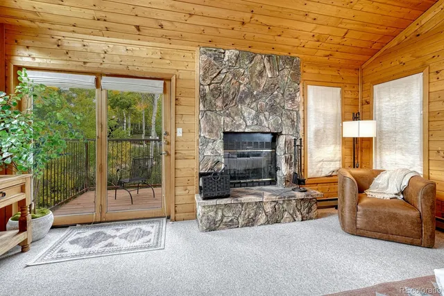 a bedroom with a bed a bookshelf and a large window