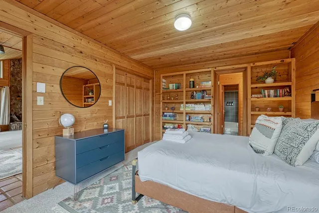 a spacious bedroom with a bed and a potted plant