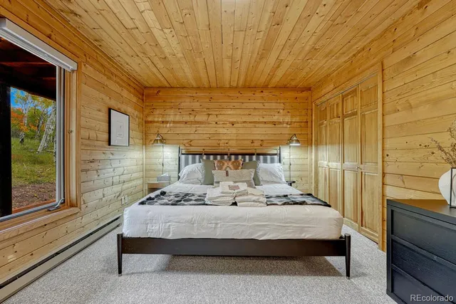 a bedroom with furniture and a large window