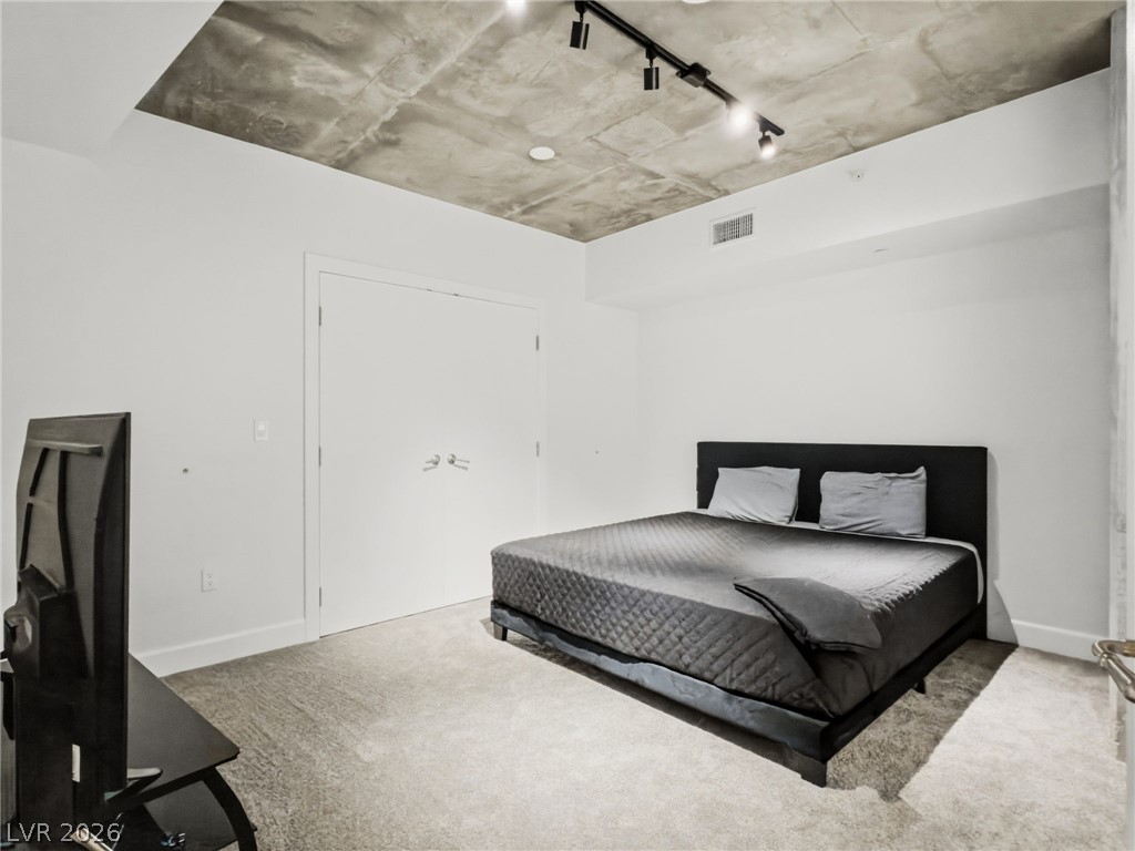 360 East Desert Inn Road, Unit 607 Las Vegas, NV 89109 - Photo 31 of 55 Industrial chic meets comfort in this modern bedroom with a unique concrete ceiling.