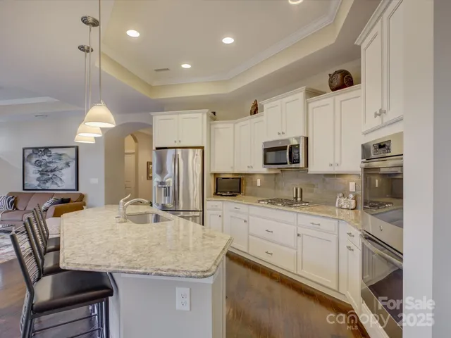 a view of a kitchen with a sink and a chandelier