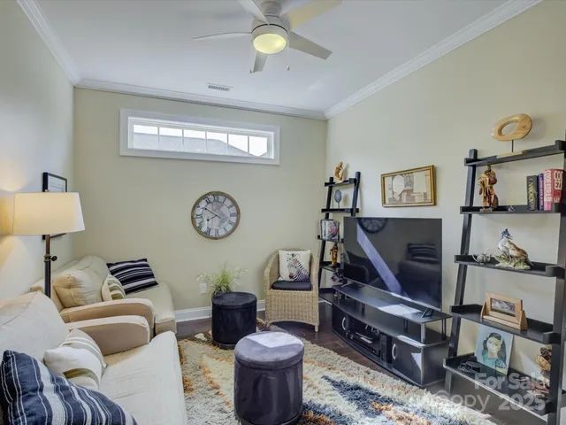 a living room with furniture a clock and a window