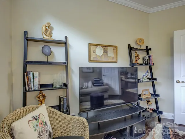 a living room with furniture a lamp a table and a window