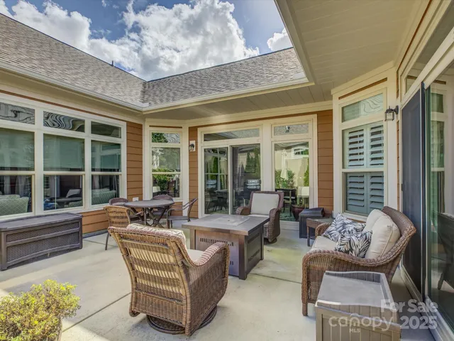 a view of a patio with table and chairs and potted plants