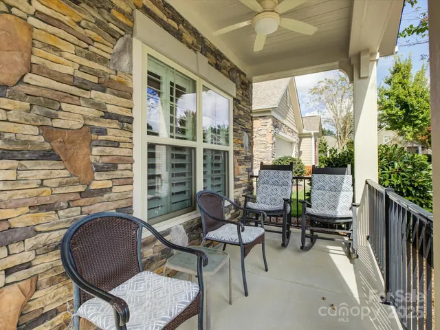a balcony with chairs and a table