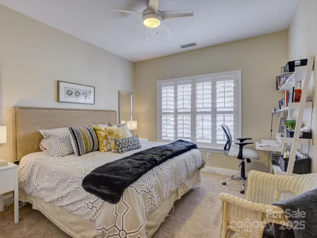 a spacious bedroom with a bed and a couch