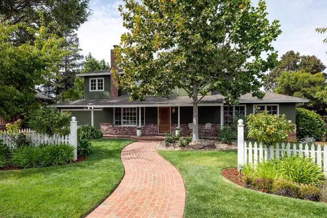 a front view of house with a garden and patio