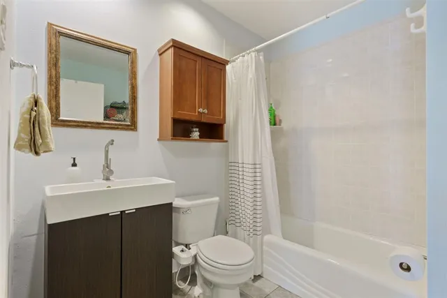 a view of a workspace with furniture and a bookshelf
