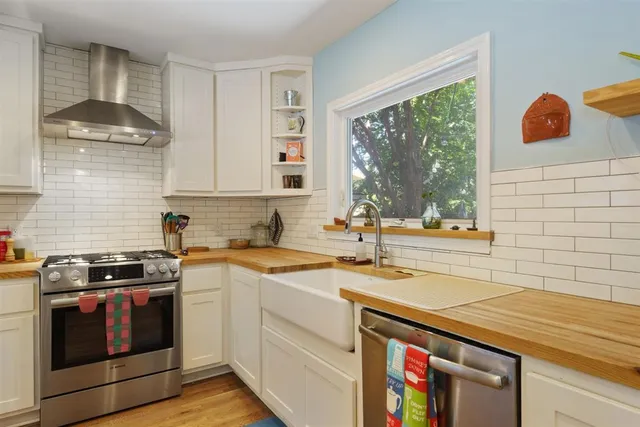 a kitchen with stainless steel appliances granite countertop a sink and a stove