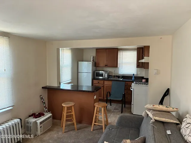 a kitchen with stainless steel appliances kitchen island granite countertop a sink and cabinets