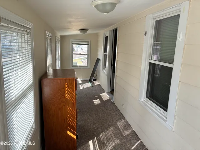 a view of a livingroom with wooden floor and a window