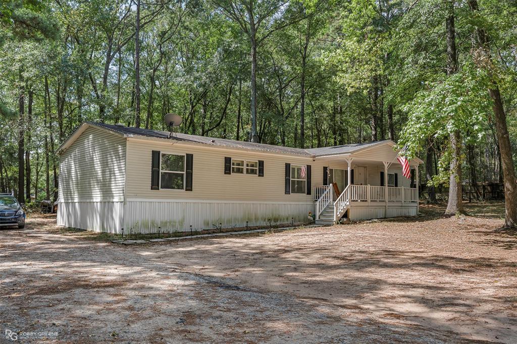 8273 Godfrey Road Shreveport, LA 71129 - Photo 2 of 27 Expansive lot with mature trees, offering a private setting