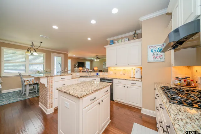 a kitchen with a stove a sink and a refrigerator