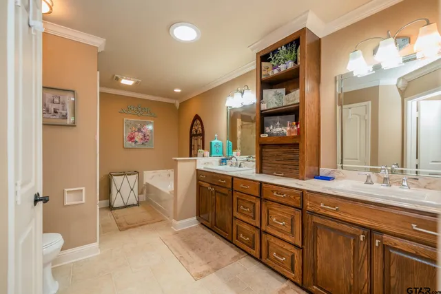 a spacious bathroom with a double vanity sink and a mirror