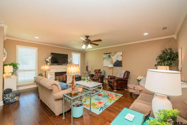 a living room with furniture a fireplace and a flat screen tv