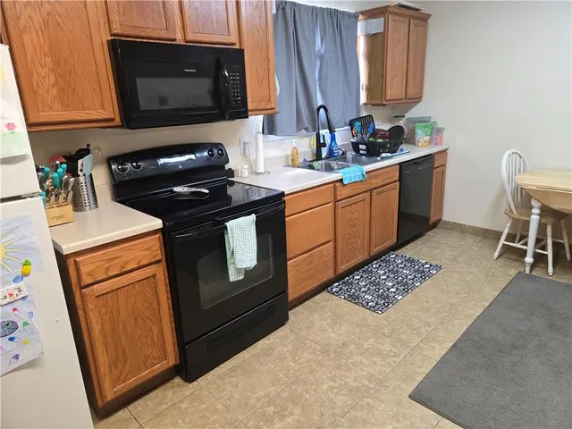 a kitchen with a stove a sink and a microwave