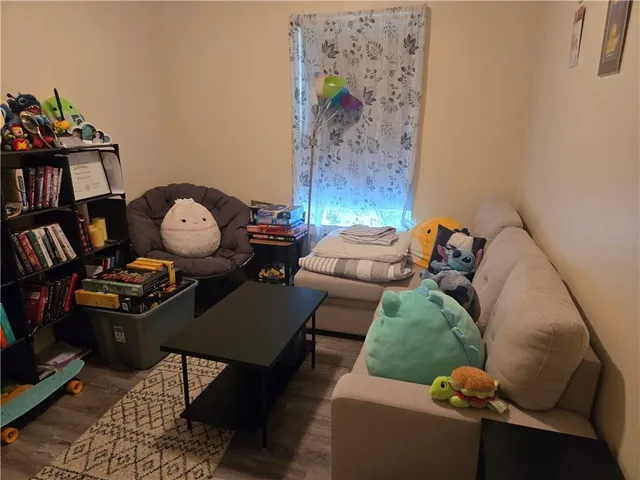 a living room with furniture and a bookshelf