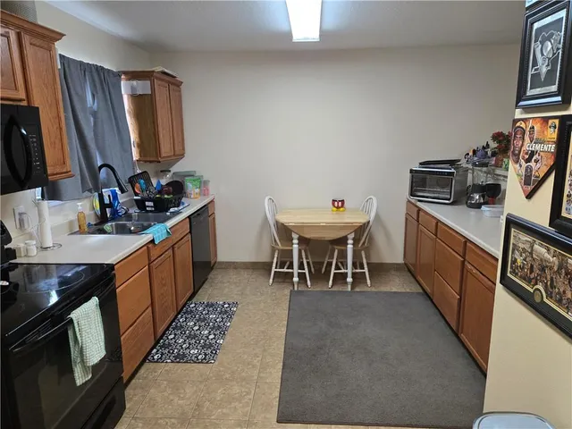 a kitchen with a sink appliances and cabinets
