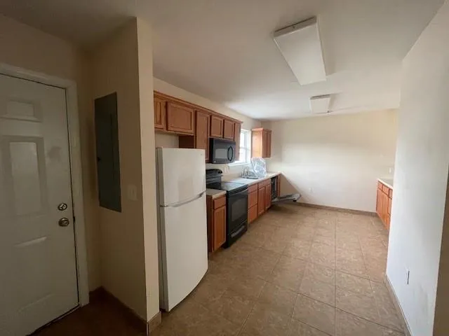 a kitchen with stainless steel appliances granite countertop a refrigerator and a stove