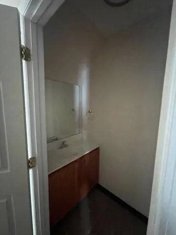 a bathroom with a sink and mirror