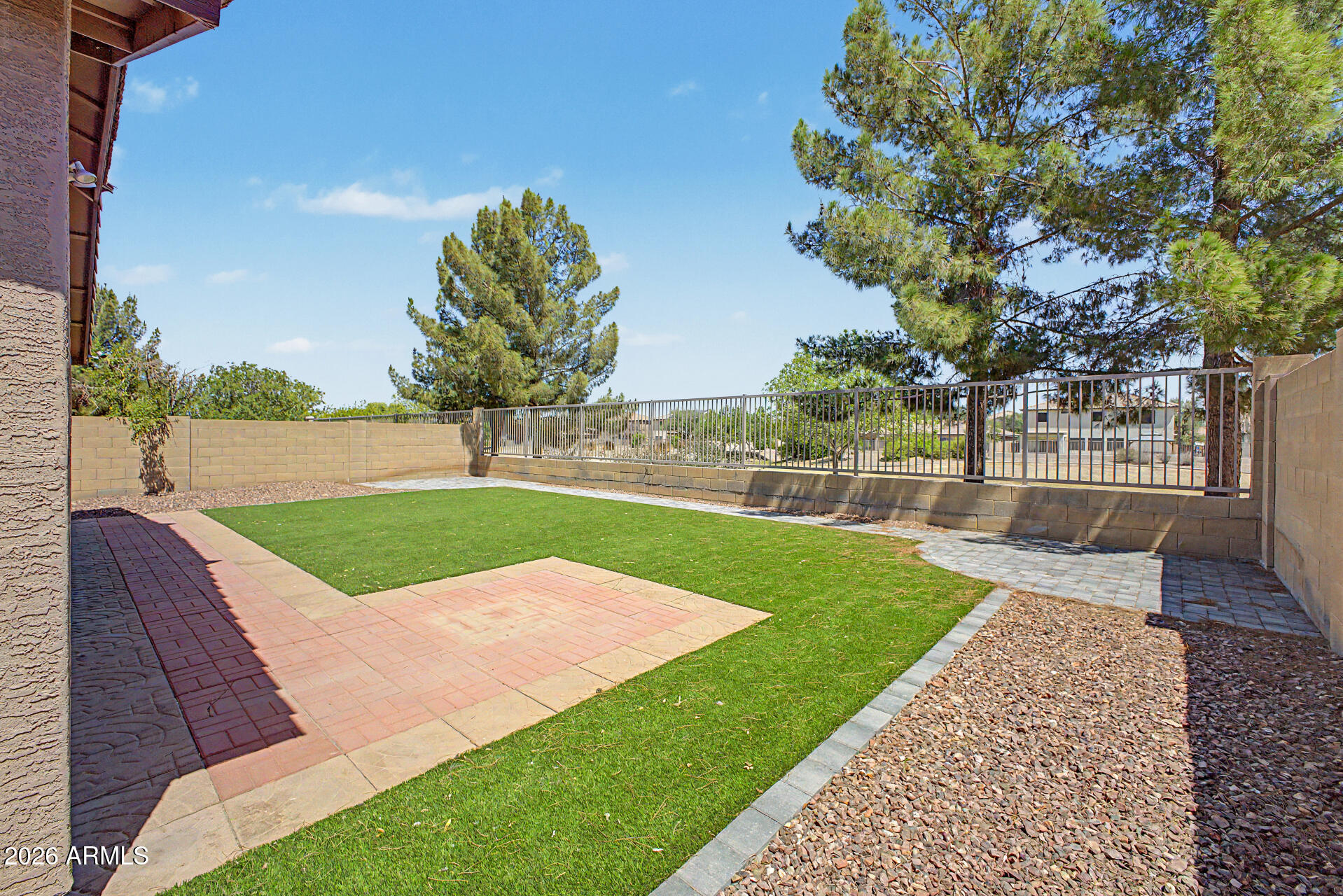 2340 West Apollo Road Phoenix, AZ 85041 - Photo 25 of 26 a view of a backyard with lawn chairs potted plants and large tree