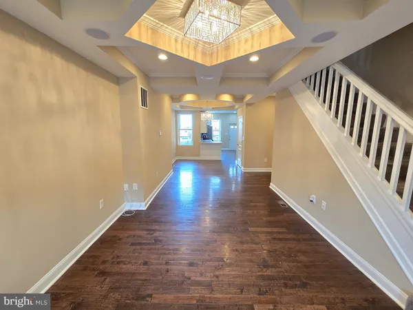 a view of staircase with wooden floor and white walls