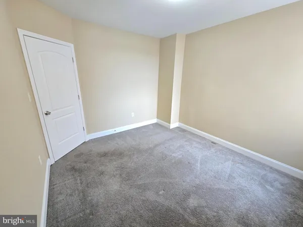 a view of hallway with a white door