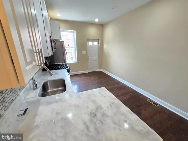 a view of a room with wooden floor and window