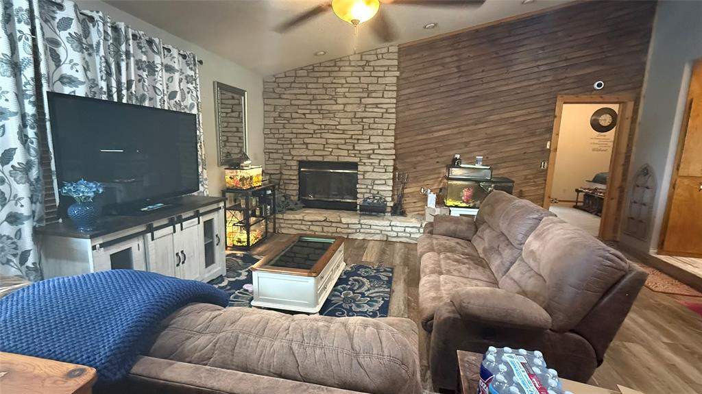 1356 Kerry Lane Azle, TX 76020 - Photo 7 of 27 Living area featuring a stone-clad fireplace and hearth