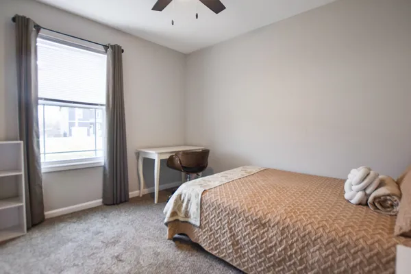 a bedroom with a bed and a window