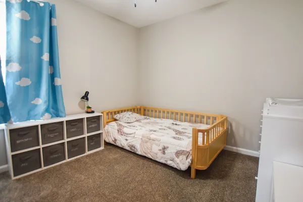 a bedroom with a bed and a window