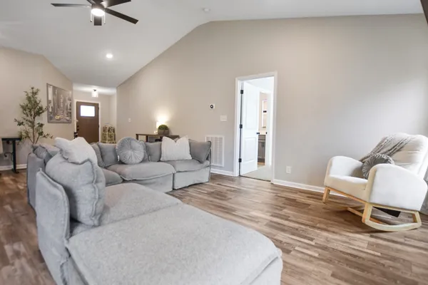 a living room with furniture and a wooden floor