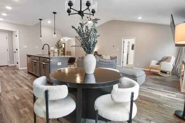 a dining room with furniture and wooden floor