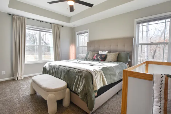 a bedroom with a bed and a large window