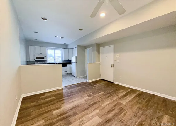 a view of a kitchen with a sink and a refrigerator