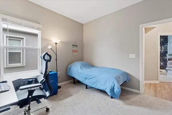 a bedroom with a bed and a chair